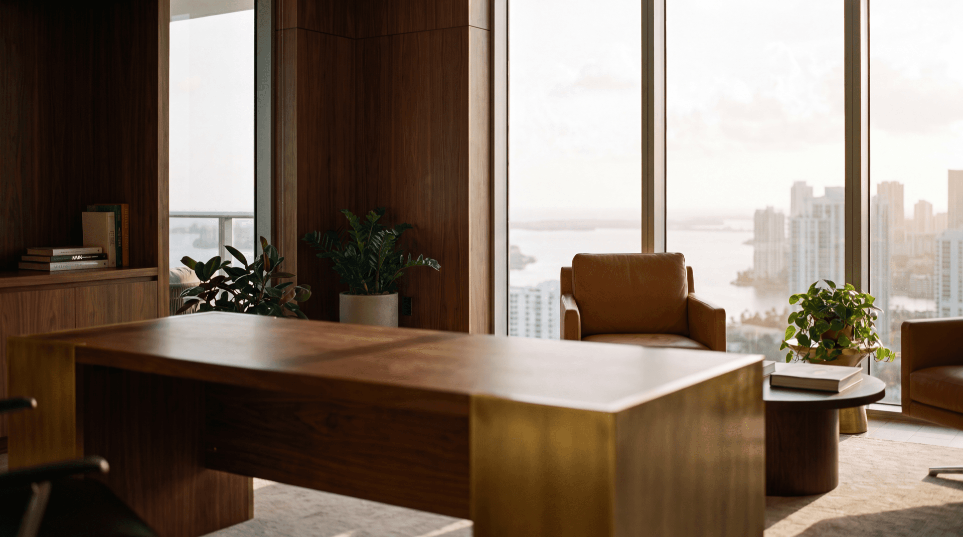 Sophisticated financial advisory office in a South Florida high-rise with walnut paneling, brass fixtures, and a golden-hour view of the Miami skyline
