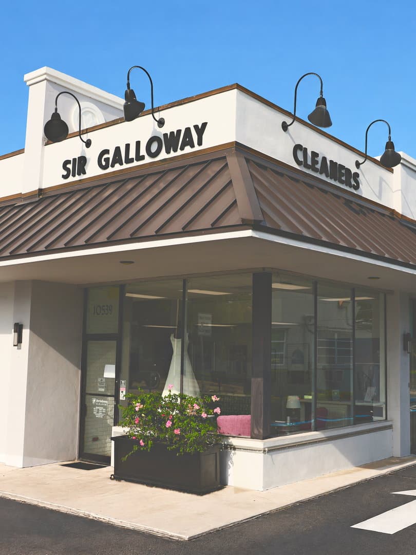 The Sir Galloway storefront in Pinecrest: SIR GALLOWAY in dark letters above a dark metal roof, a wedding gown in the window and 10539 on the glass